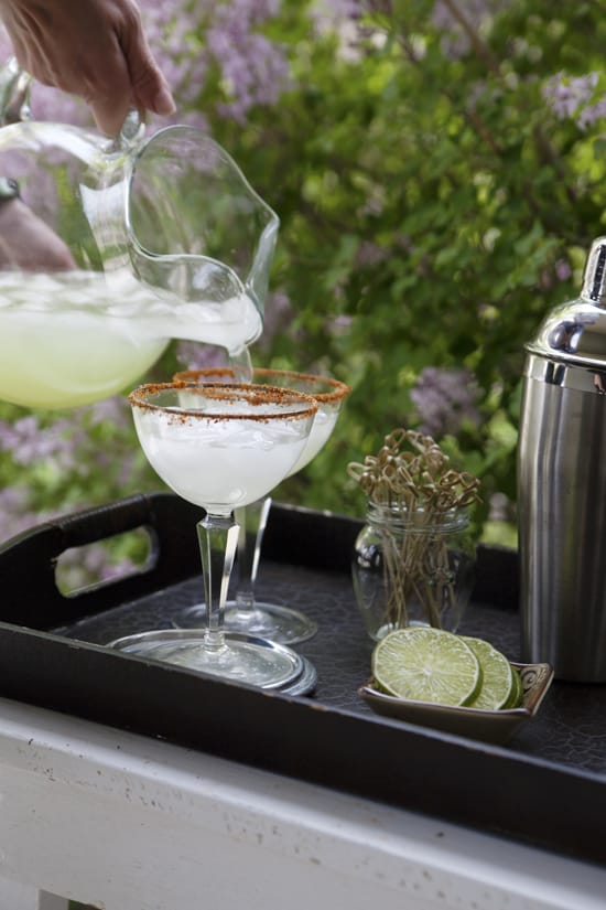 cucumber margaritas poured into glasses outdoors