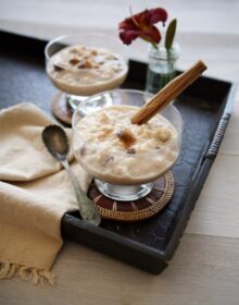 mexican rice pudding, known as arroz con leche, in short coupe glasses and garnished with cinnamon on a black serving tray