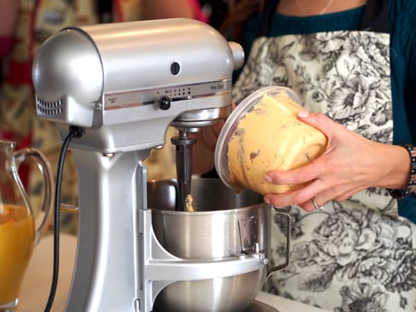 Basic Tamal Dough masa spooning lard into a stand mixer 