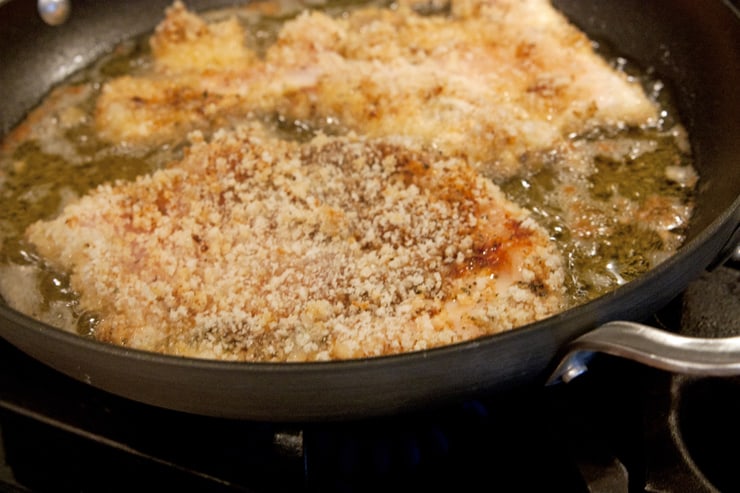 calphalon pan with hot oil frying Milanesa breaded chicken breasts