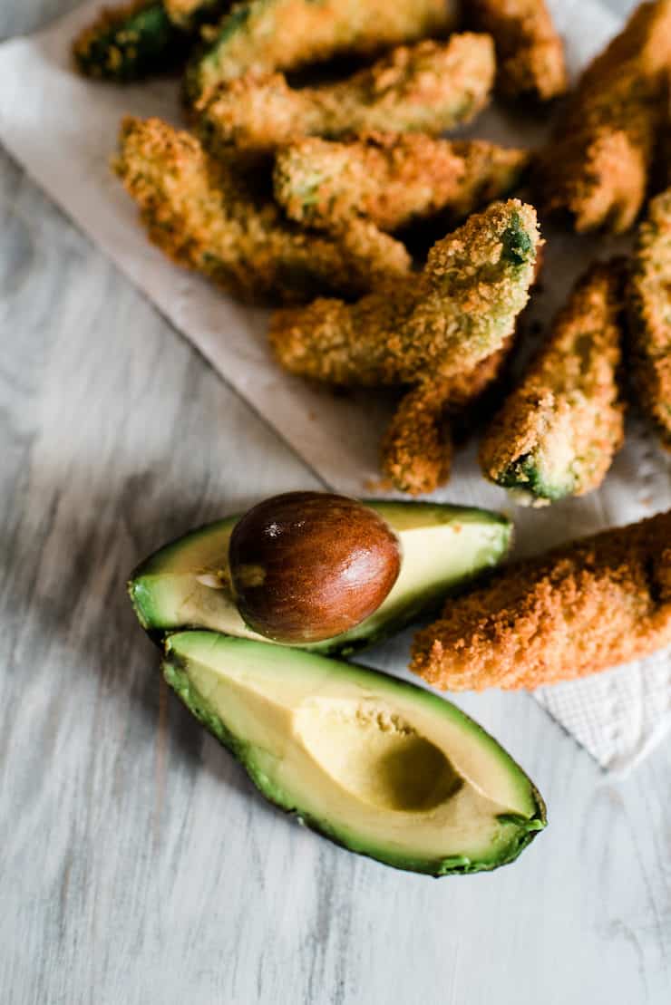 avocado fries draining on a paper towel