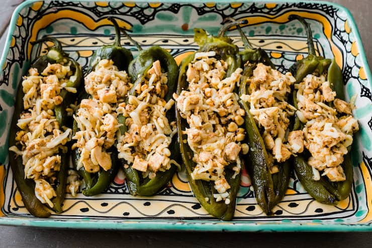 Chicken Stuffed Hatch Chiles in a colorful Talavera baking dish before baked