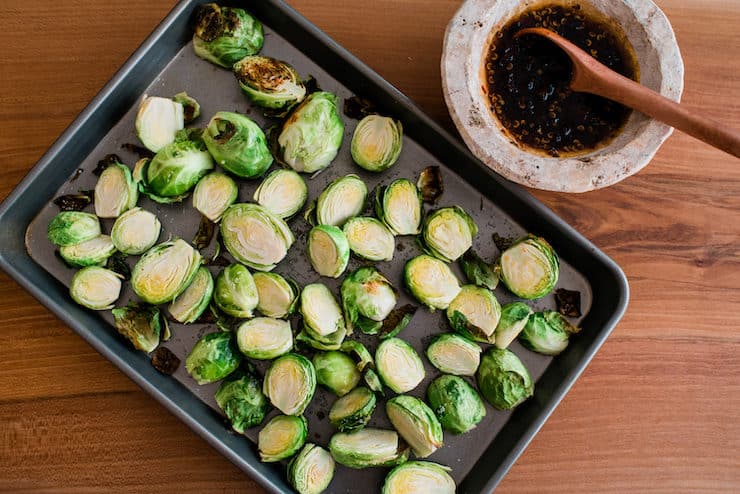 Chipotle Brussels Sprouts in a tray on a wooden table