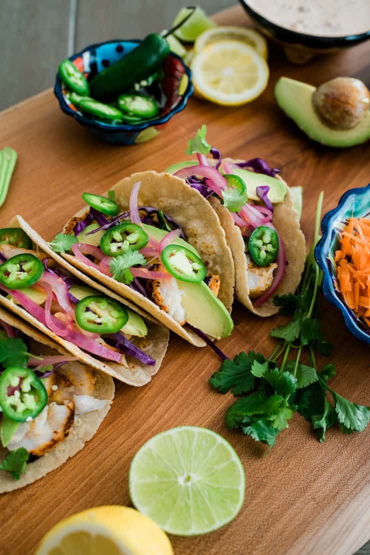 Lemon butter tacos beautifully presented on a wooden board