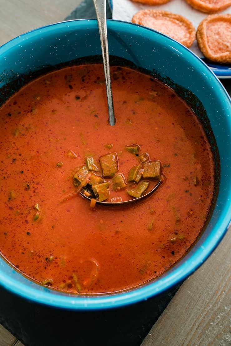 Nopales in guajillo chile sauce in a blue bowl