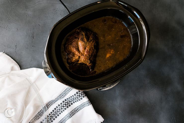 Lamb in a slowcooker in the middle of a cooking process