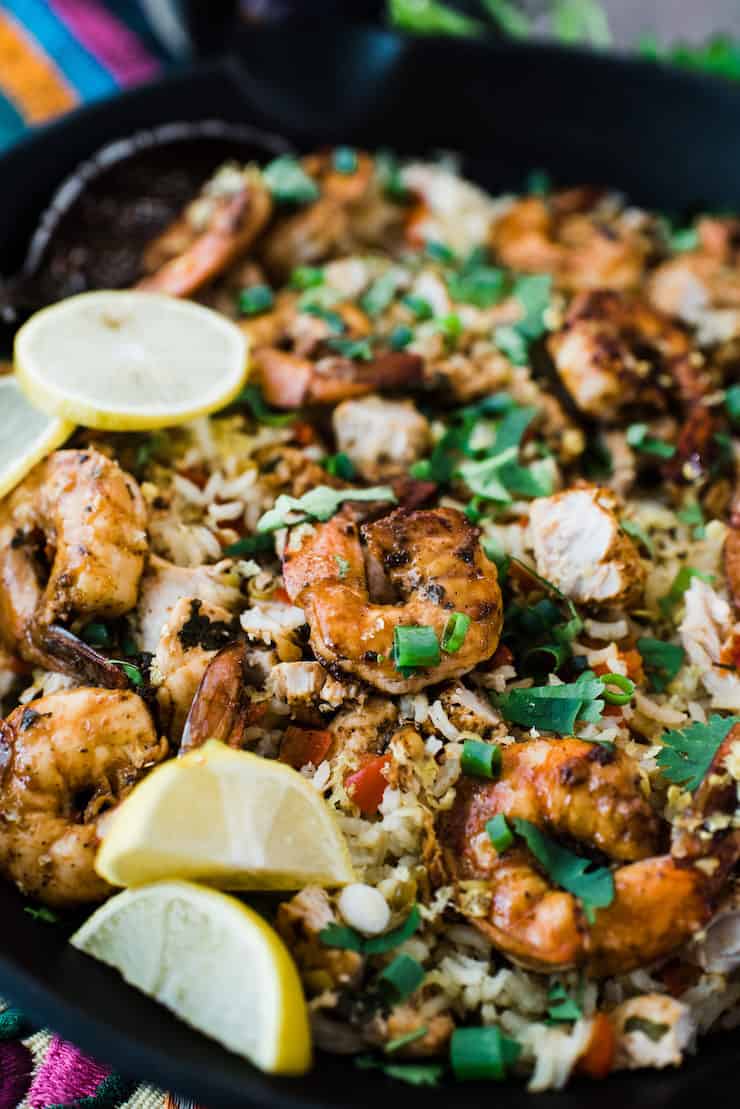 shrimp and chopped chicken with rice in an iron skillet