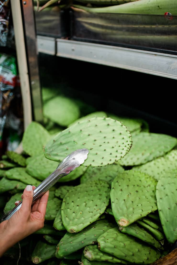 Picking up nopales in a Latin grocery store
