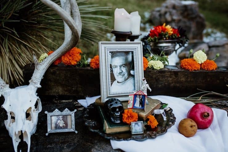 altar ofrenda elements for day of the dead dia de Los Muertos photographs marigolds candles fruits sugar skulls