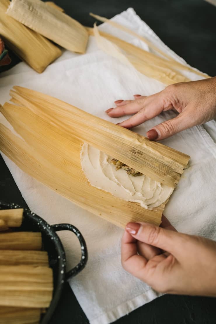 Instant Pot Pork and Roasted Green Chile Tamales fill corn husks