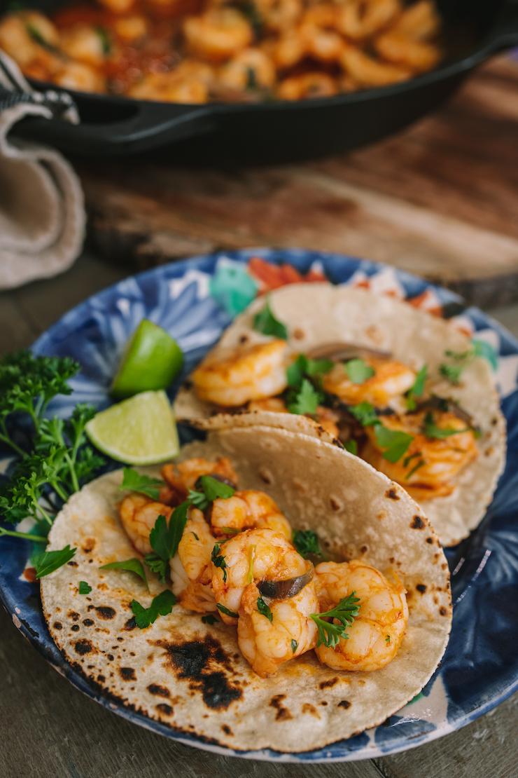 a plate with two tacos Camarones al Mojo de Ajo (Mexican-Style Garlic Shrimp)