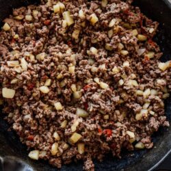 cast iron skillet filled with mexican picadillo