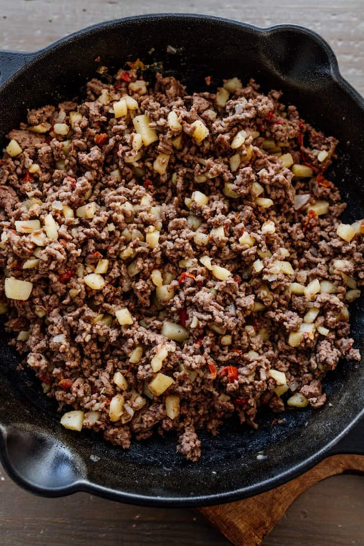 cast iron skillet filled with carne molida picadillo