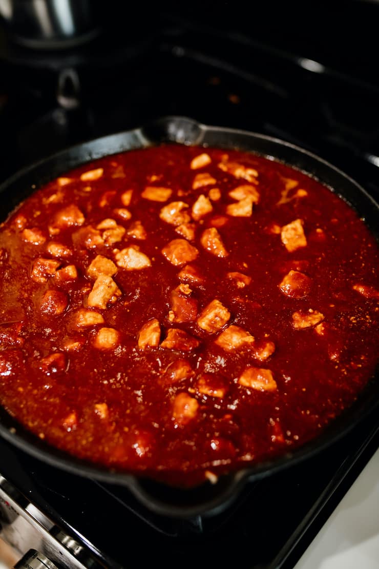 Asado de Chile Colorado (Pork in Red Chile Sauce) stew in cast iron pan