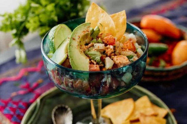 canned salmon salad ceviche style served in a glass with avocado slices and tortilla chips