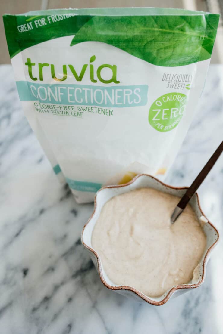 caramel icing recipe in a bowl and Truvia confectioners package