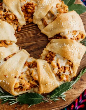 easy christmas breakfast crescent wreath on a wooden platter