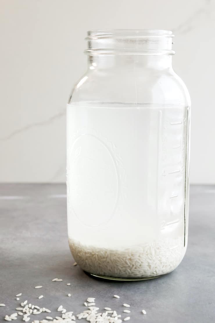 large mason jar with rice soaking in 6 cups of water
