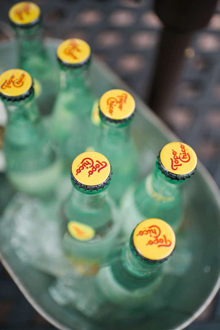 overhead shot of bottles of topo chico in a metal trough of ice