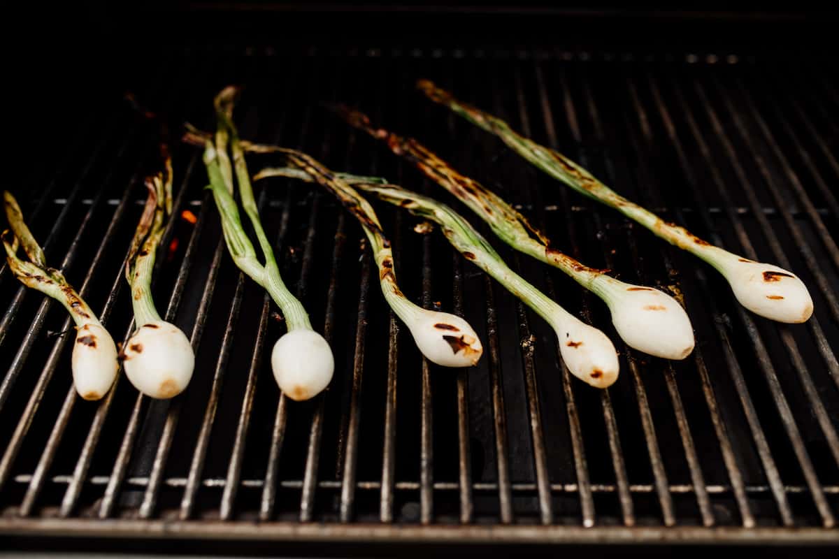 spring onions grilling directly on the grill grate