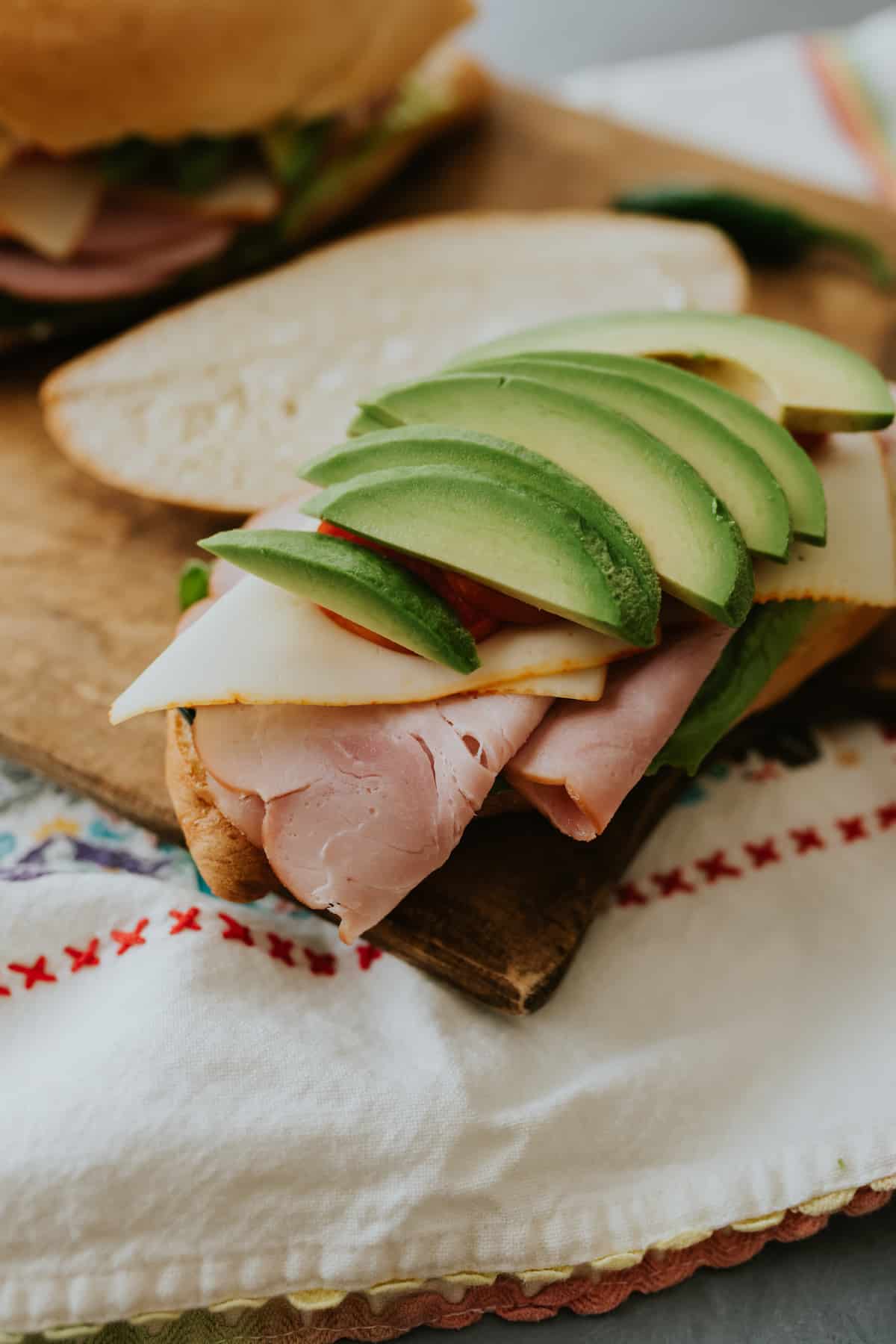avocados, tomatoes, ham and lettuce on a mexican ham sandwich