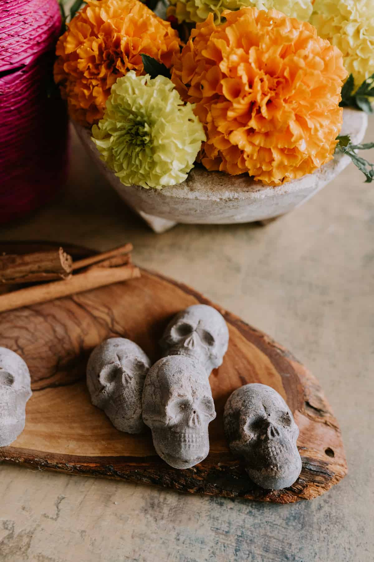 artisan mexican chocolate skulls for dia de los muertos with marigolds on the side