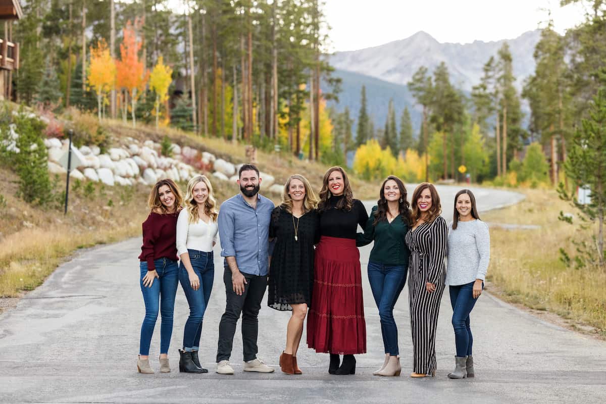The Fresh Air Retreat attendees -- 8 bloggers standing with Colorado fall trees and mountains in the background