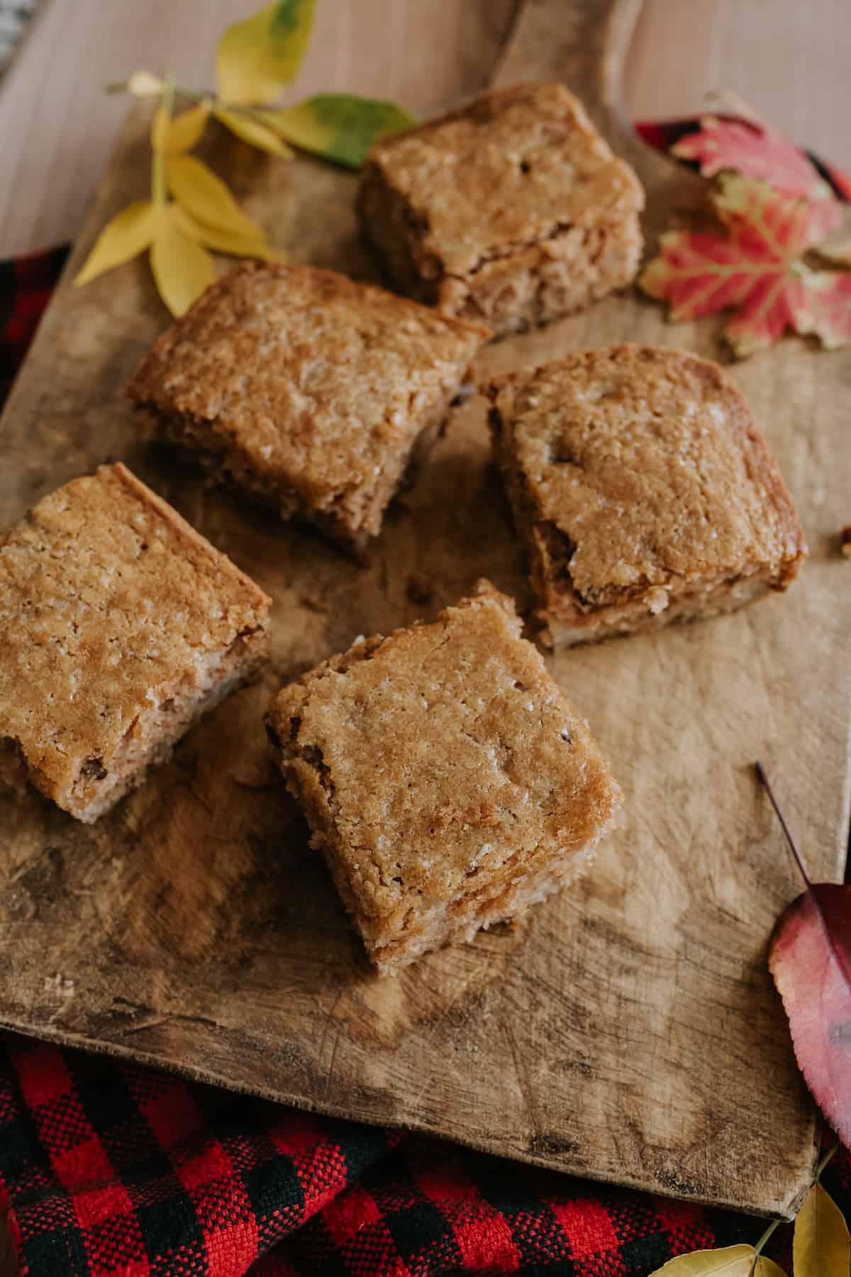 pear bread squares on a wooden board with fall leaves