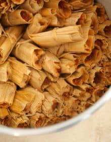 authentic mexican pork tamales rojos steaming in a tamalada.