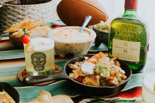 whisky sour with pork green chile fries and a football.