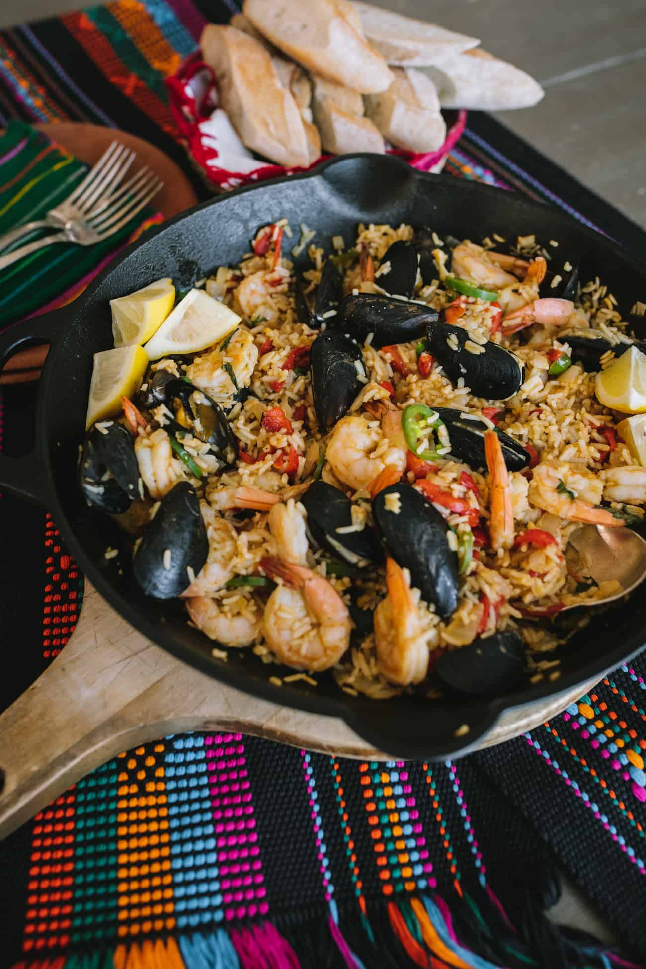 Cast iron skillet filled with easy seafood paella made with shrimp and mussels.