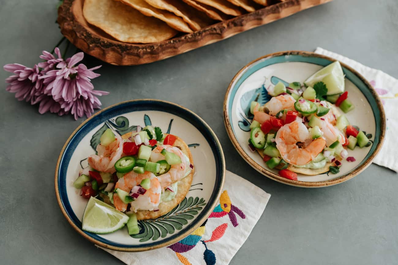two plates with a shrimp ceviche tostadas.