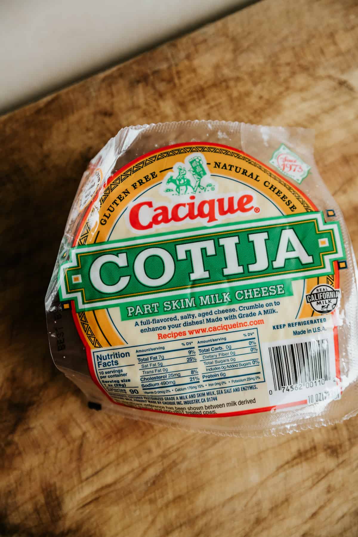 a container of cacique brand cotija cheese in its packaging.