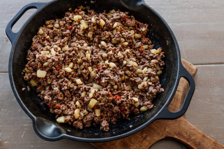 overhead shot of mexican picadillo in a cast iron skillet. 