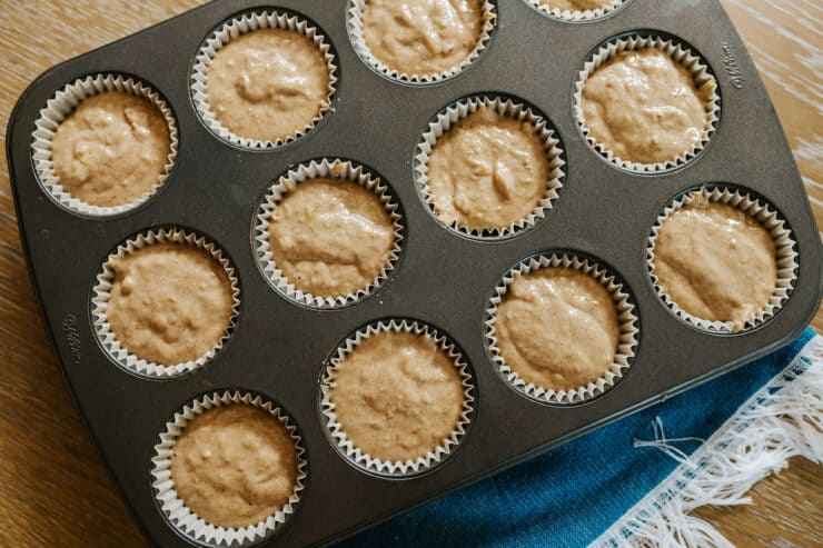 overhead shot of unbaked banana oat flour muffins in the tin.