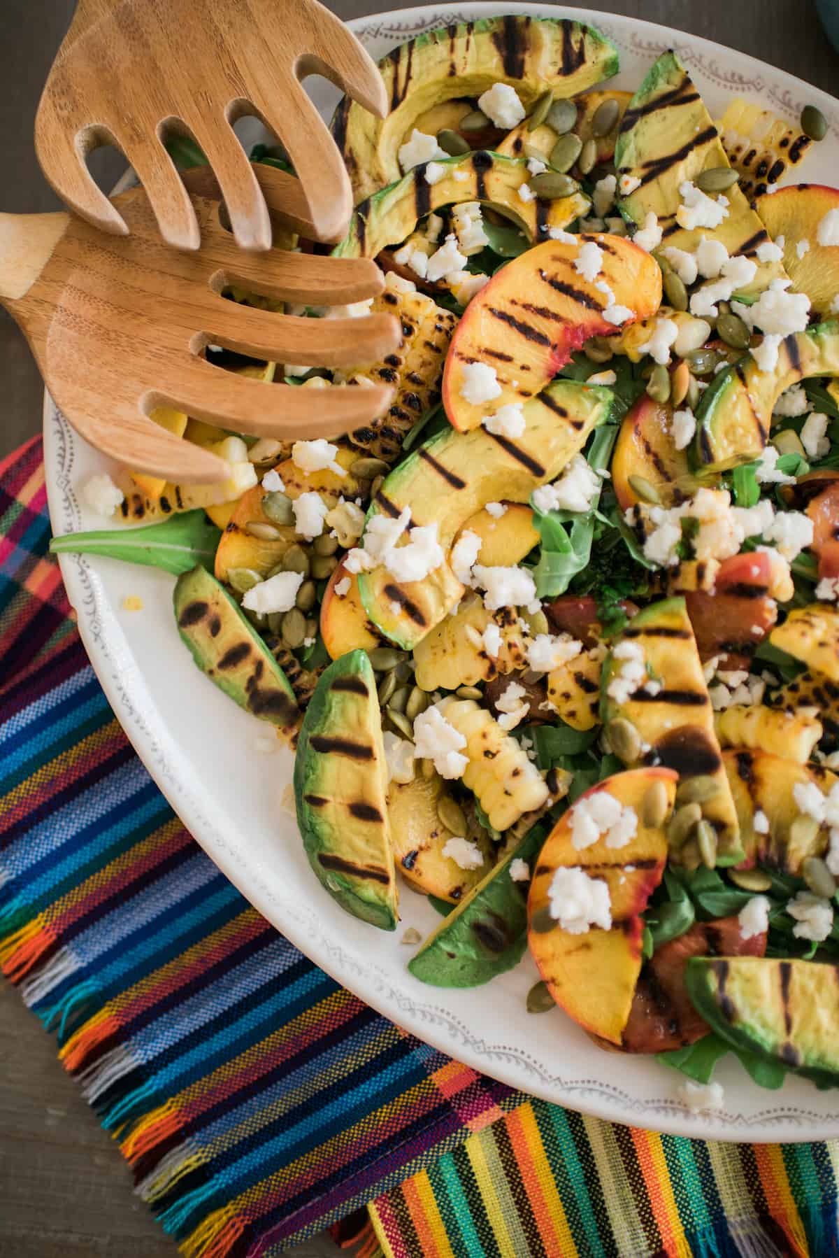 salad with grilled corn, grilled avocado, and grilled stone fruit with salad claws.