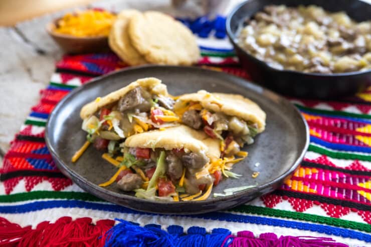 gorditas mexicanas de chile verde con carne y papas on a grey stoneware plate. 
