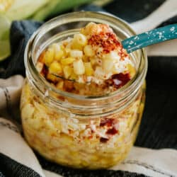 mexican street corn in a mason jar with turquoise spoon.
