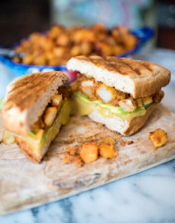 Breakfast Tortas with Potatoes and Chorizo cut open on a cutting board.