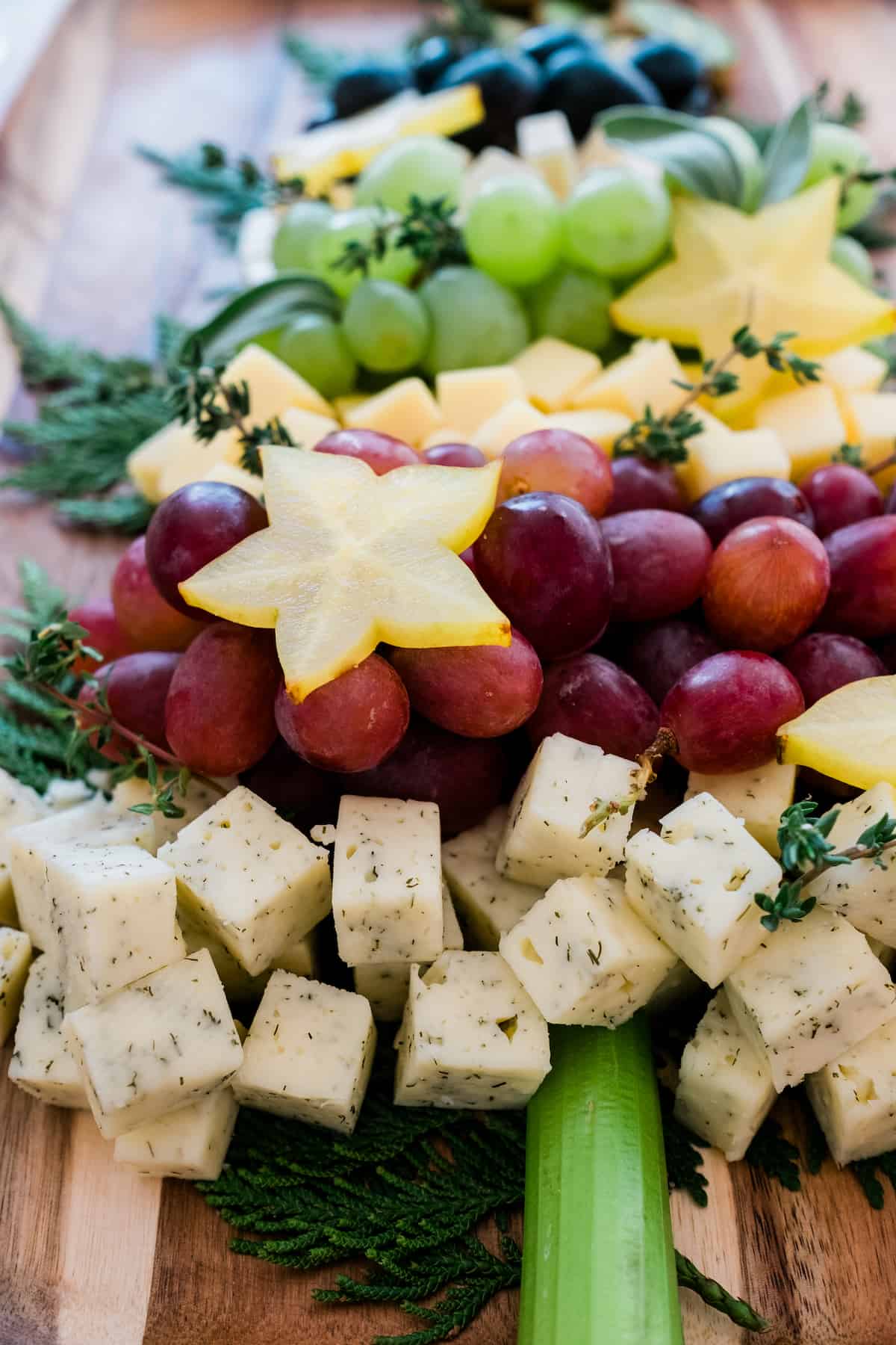 Christmas Tree Cheese Board with a celery as the trunk and star fruit ornaments.