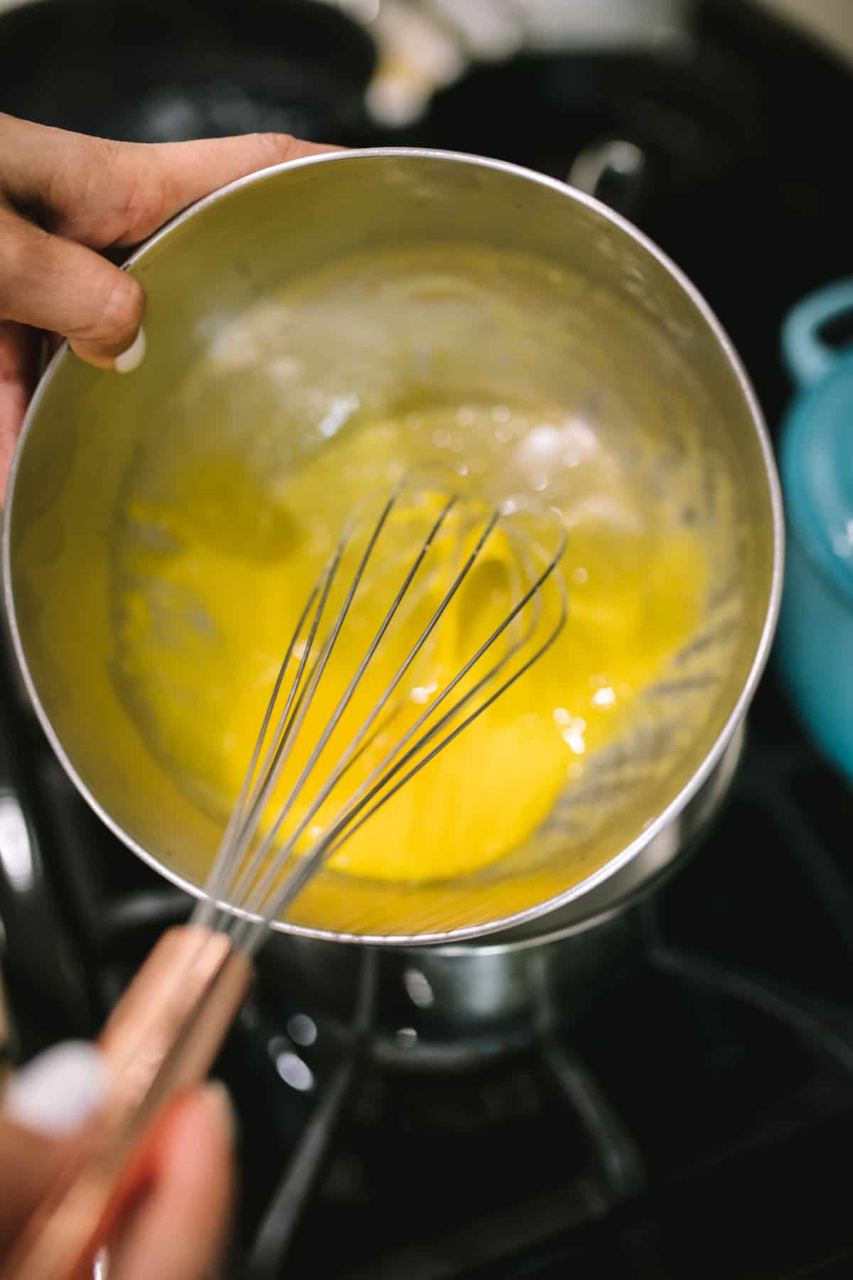 using a whisk to make hollandaise.