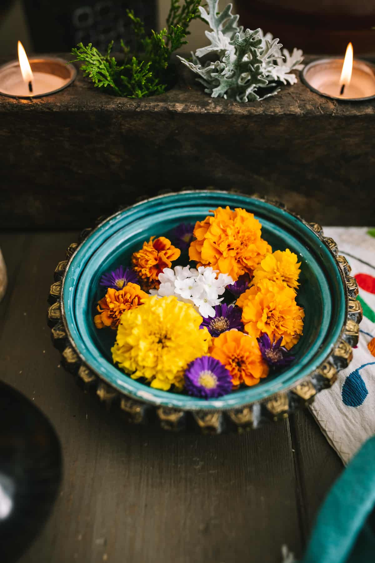 bowl of marigolds and other edible flowers on a dia de los muertos altar. 