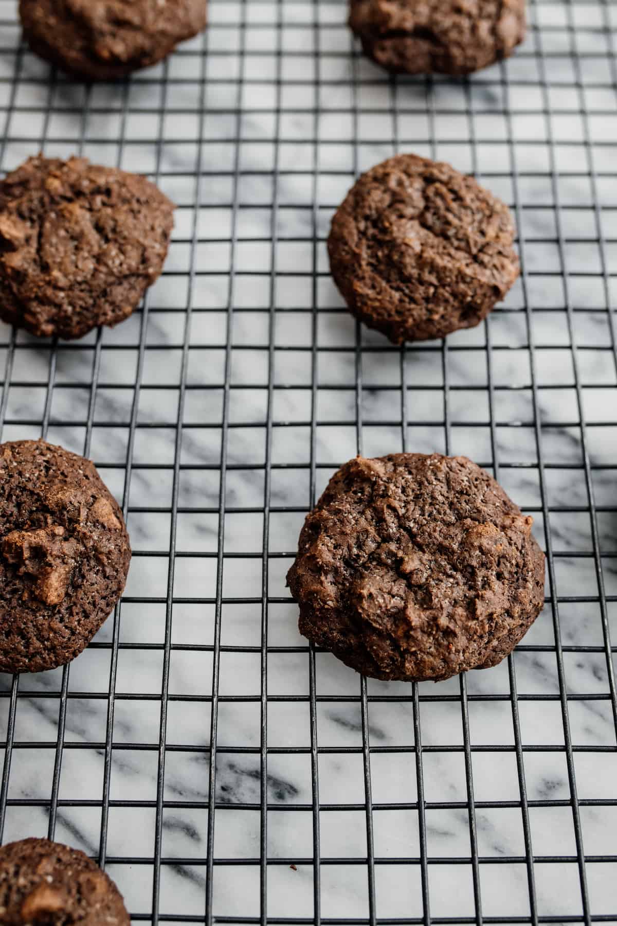 mexican hot chocolate cookies cooling on a metal rack after baking. 