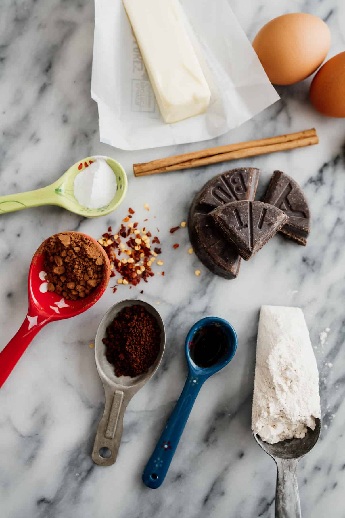 ingredients needed to make Mexican hot chocolate cookies measured out on a marble surface.