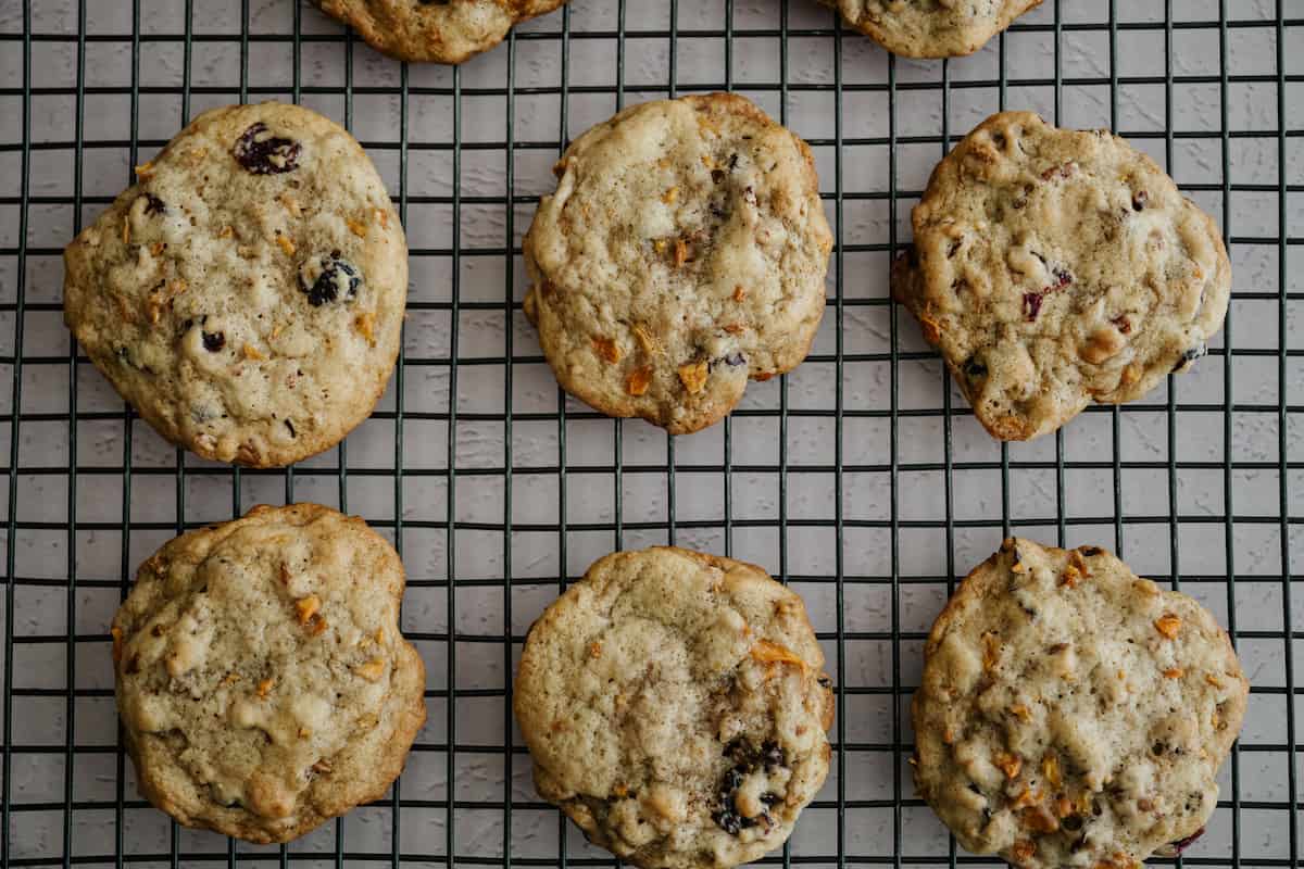 persimmon cookies with raisins and nuts cooling on a cookie rack.