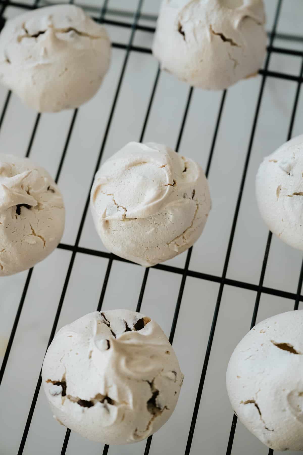 healthy chocolate chip meringue cookies cooling on a rack.