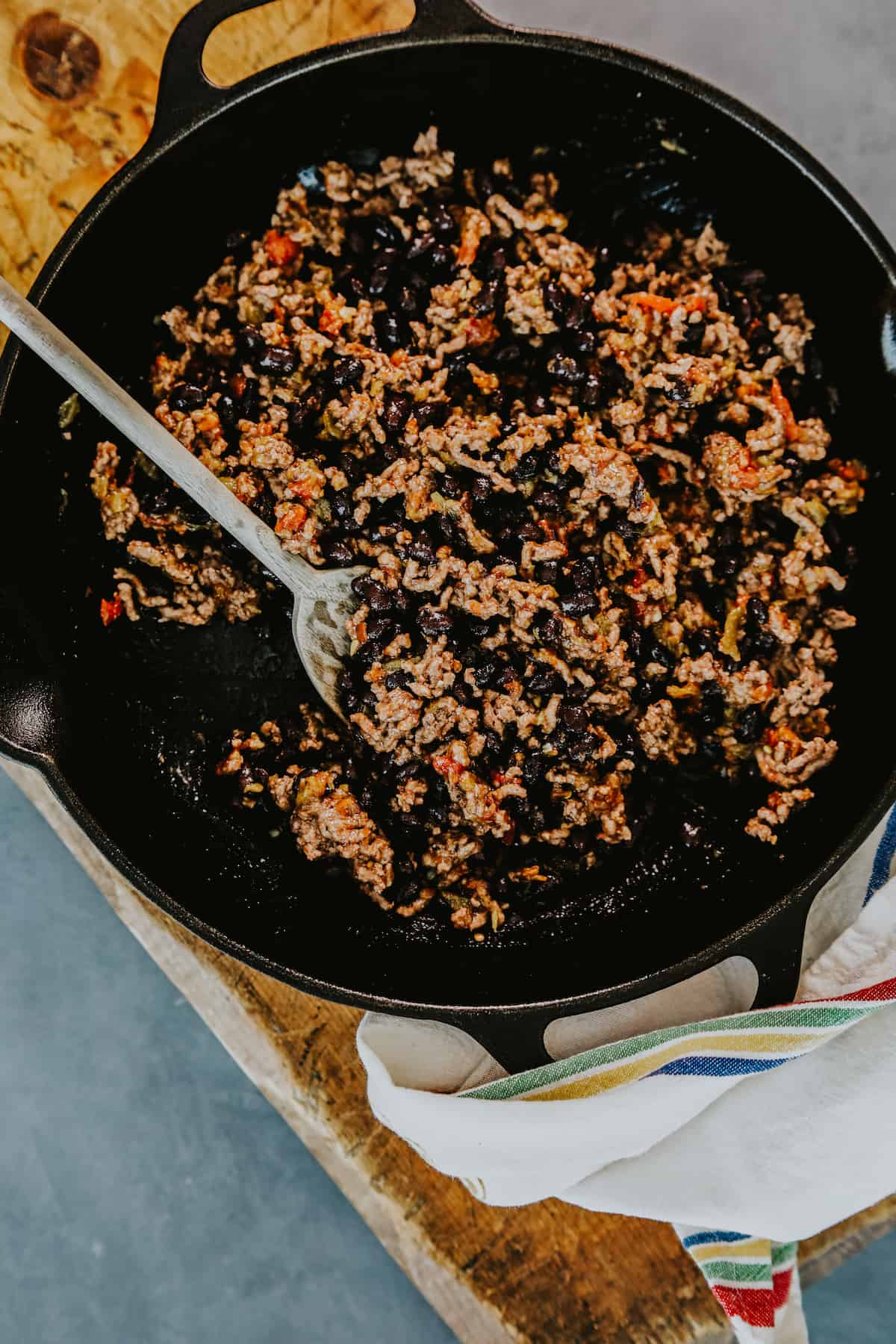 ground beef and black bean nacho topping mixture in a cast iron skillet.