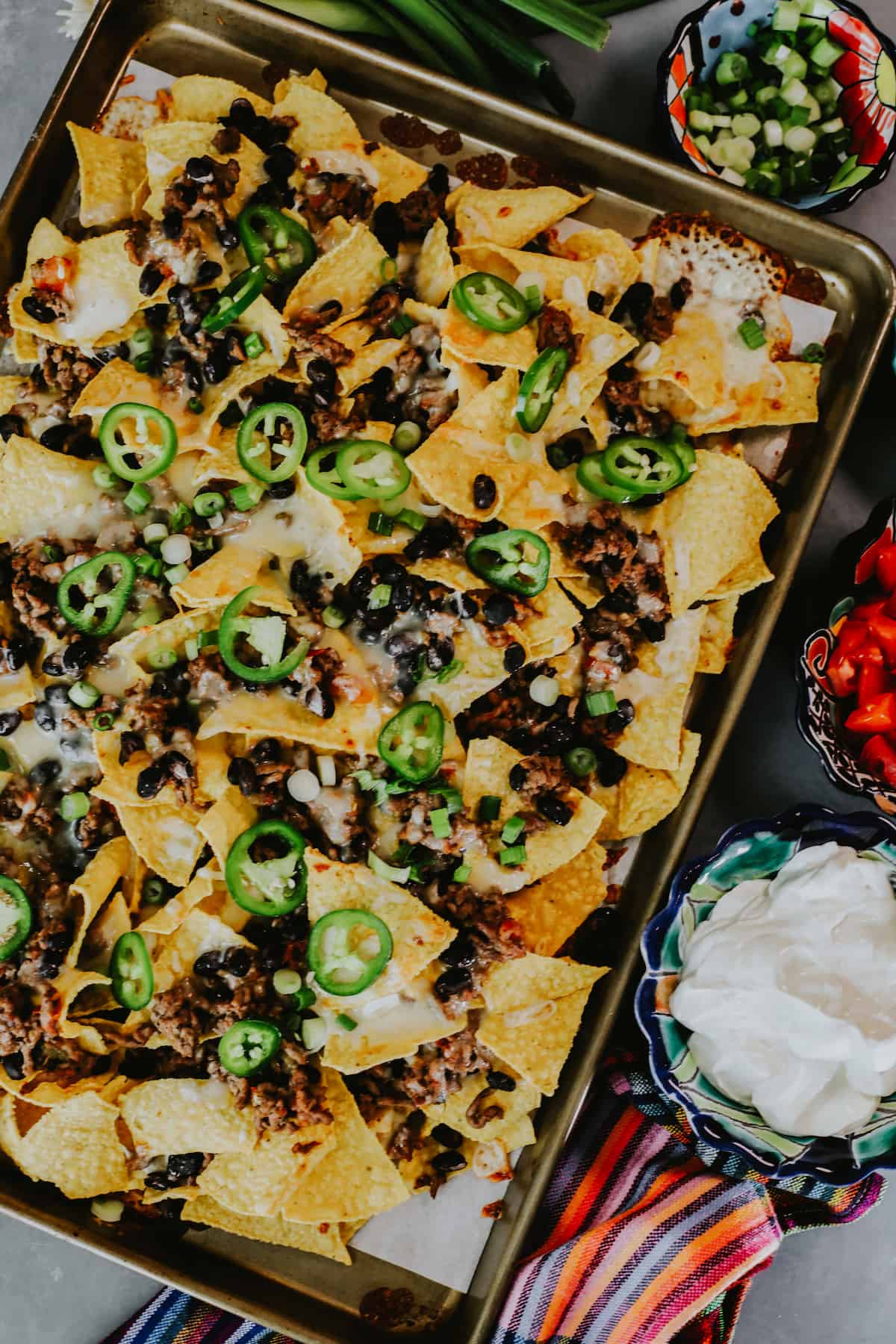 overhead shot of sheet pan nachos with ground beef and beans.